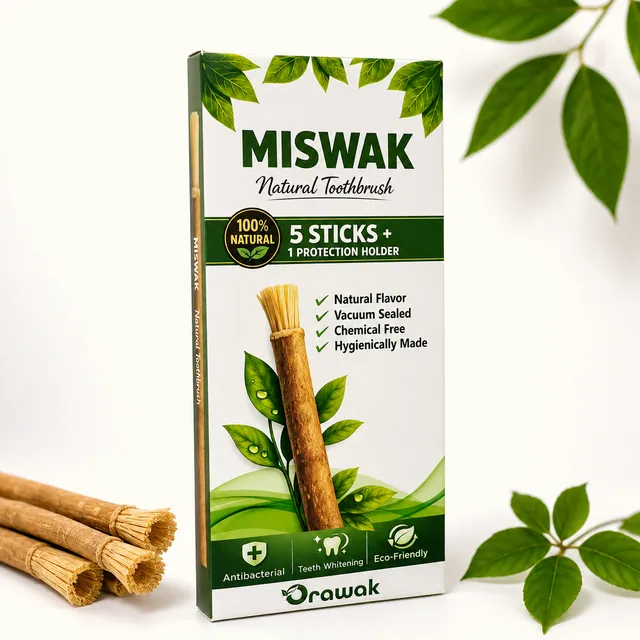 Orawak miswak carton standing beside a bundle of loose miswak sticks on a white ground