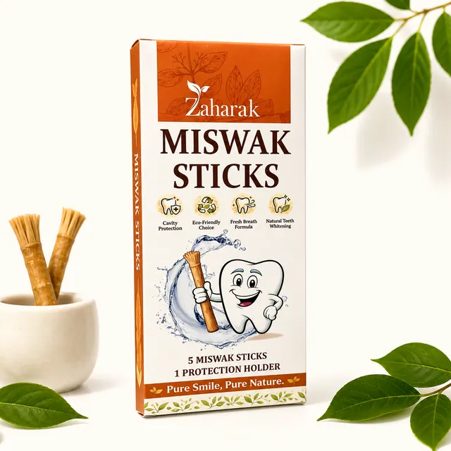 Zaharak miswak sticks carton in terracotta and cream, beside a ceramic cup holding two miswak sticks